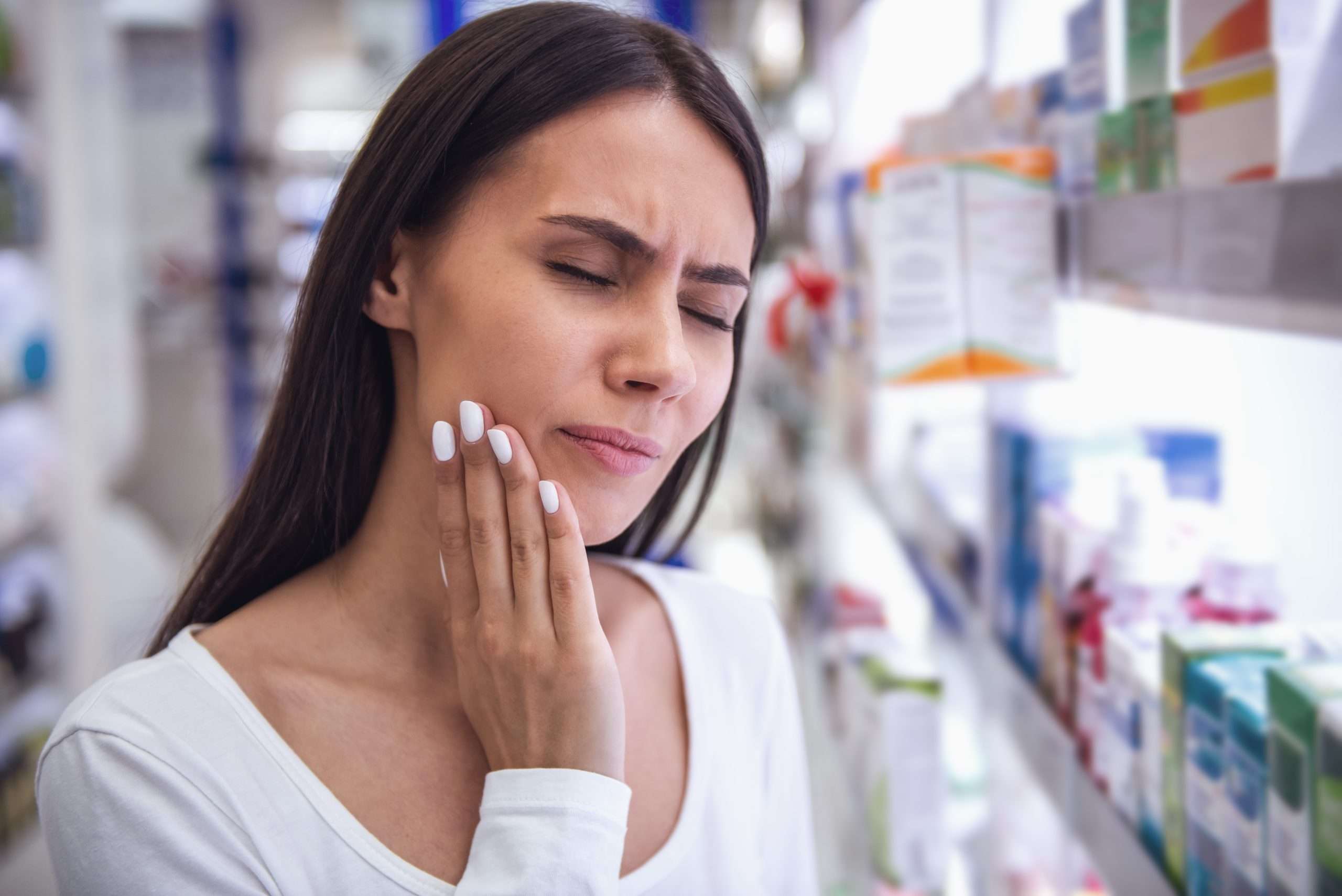 Beautiful young woman is having a toothache