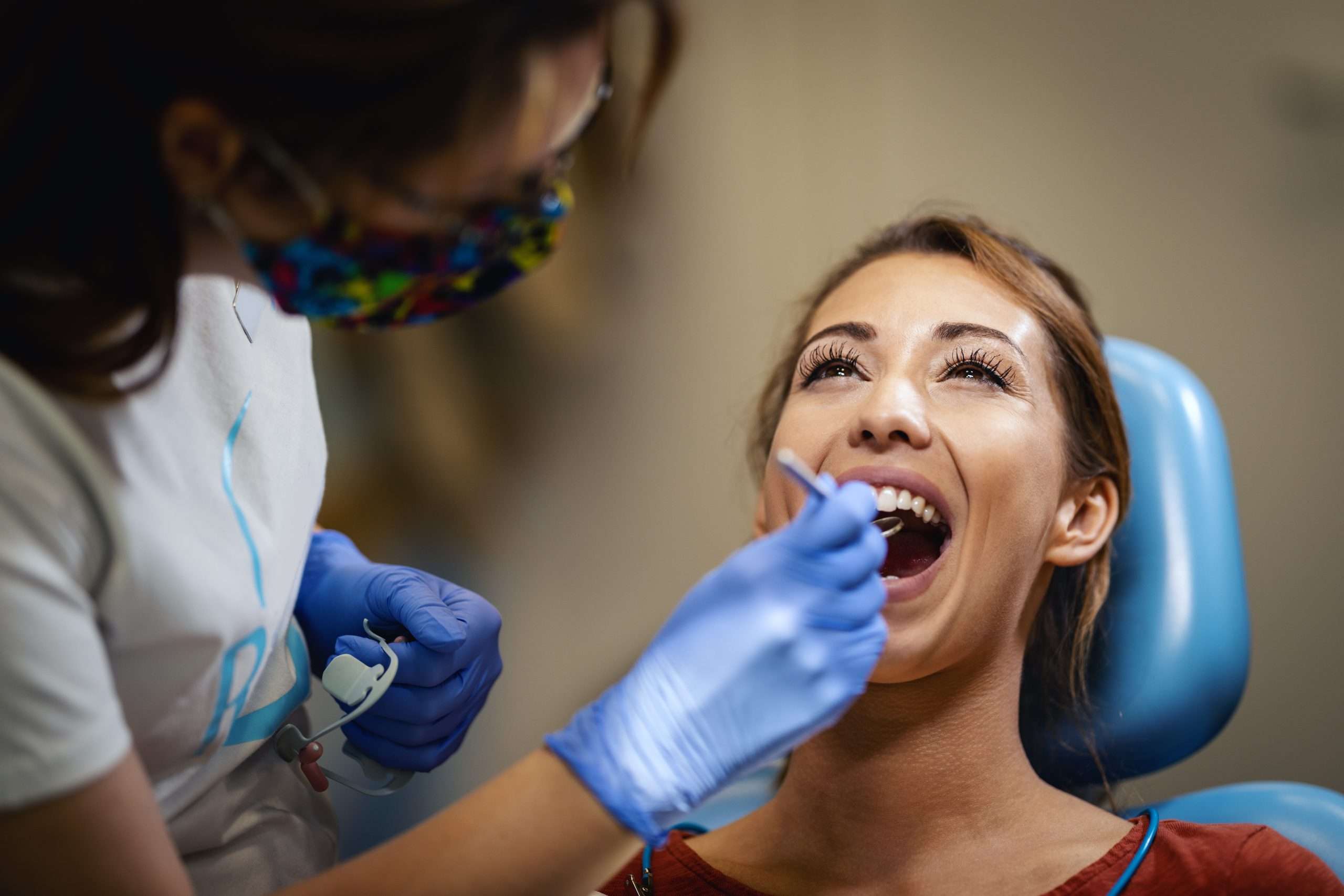 The beautiful young woman is at the dentist
